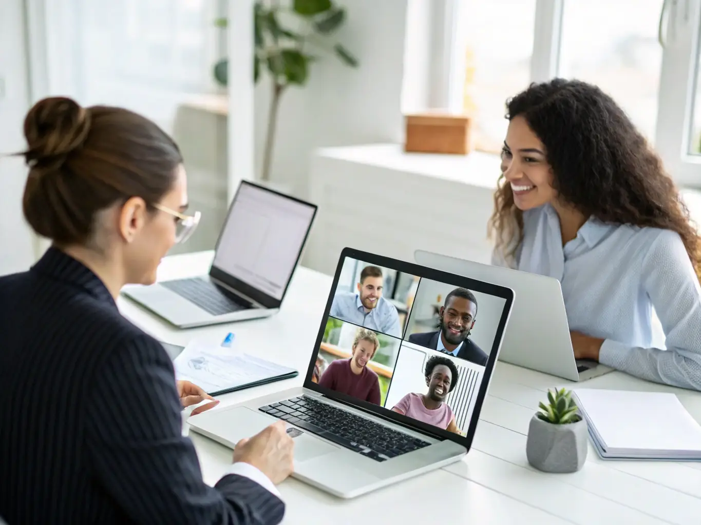 A diverse team of remote workers collaborating seamlessly using a cloud phone system, highlighting the flexibility and accessibility of the technology.